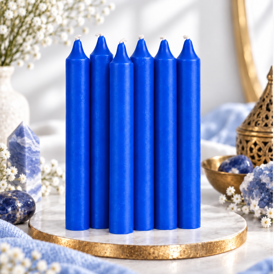 Set of six blue 6-inch intention candles with blue crystals and white flowers on a bright white background