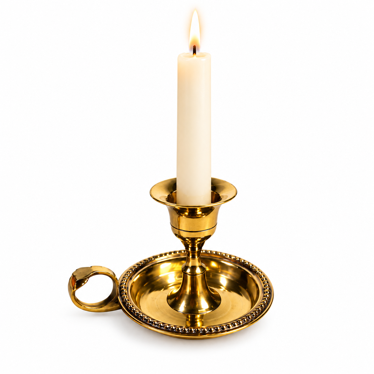 Brass chamberstick taper candle holder with white candle on white background