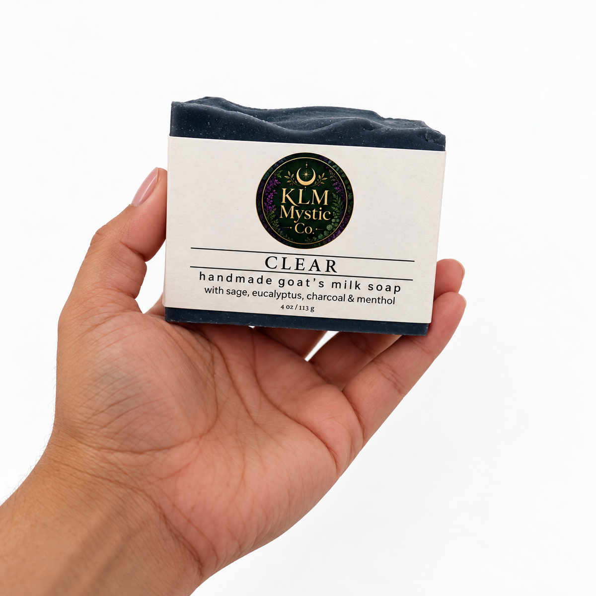 Deep-blue CLEAR goat’s milk soap held in the owner’s hand