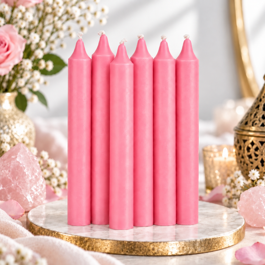 Set of six pink 6-inch intention candles with pink roses and rose quartz on a bright white background